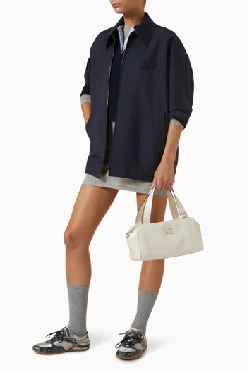 حقيبة بيد علوية وشعار الماركة جلد عجل