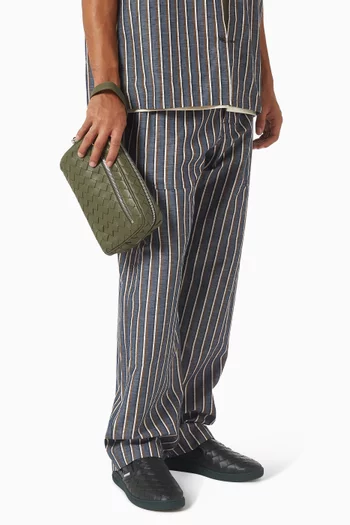 حقيبة صغيرة بحمالة معصم جلد مجدول